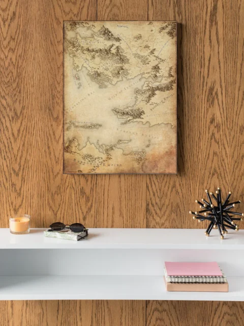 Parchment-style fantasy map with deserts, seas, and mountain ranges