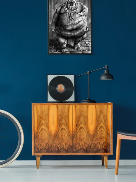 Bloated demon roaring inside a chained chamber