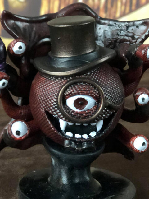 Three-quarter angle showing dramatic cape spread and stance