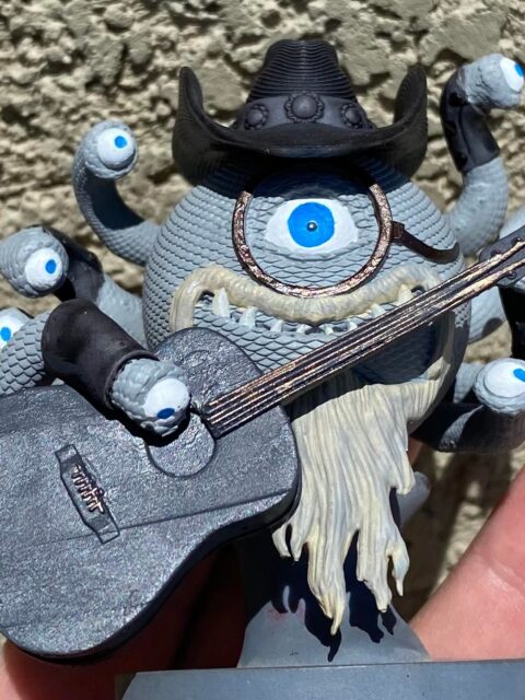 Front view of JCM holding instrument in performance pose