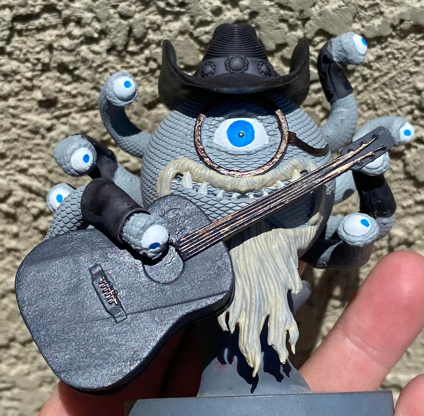 Front view of JCM holding instrument in performance pose