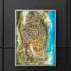 Aerial view of a fortified coastal city with concentric defensive walls.