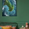 Large tropical island surrounded by bright turquoise waters with depth gradients.