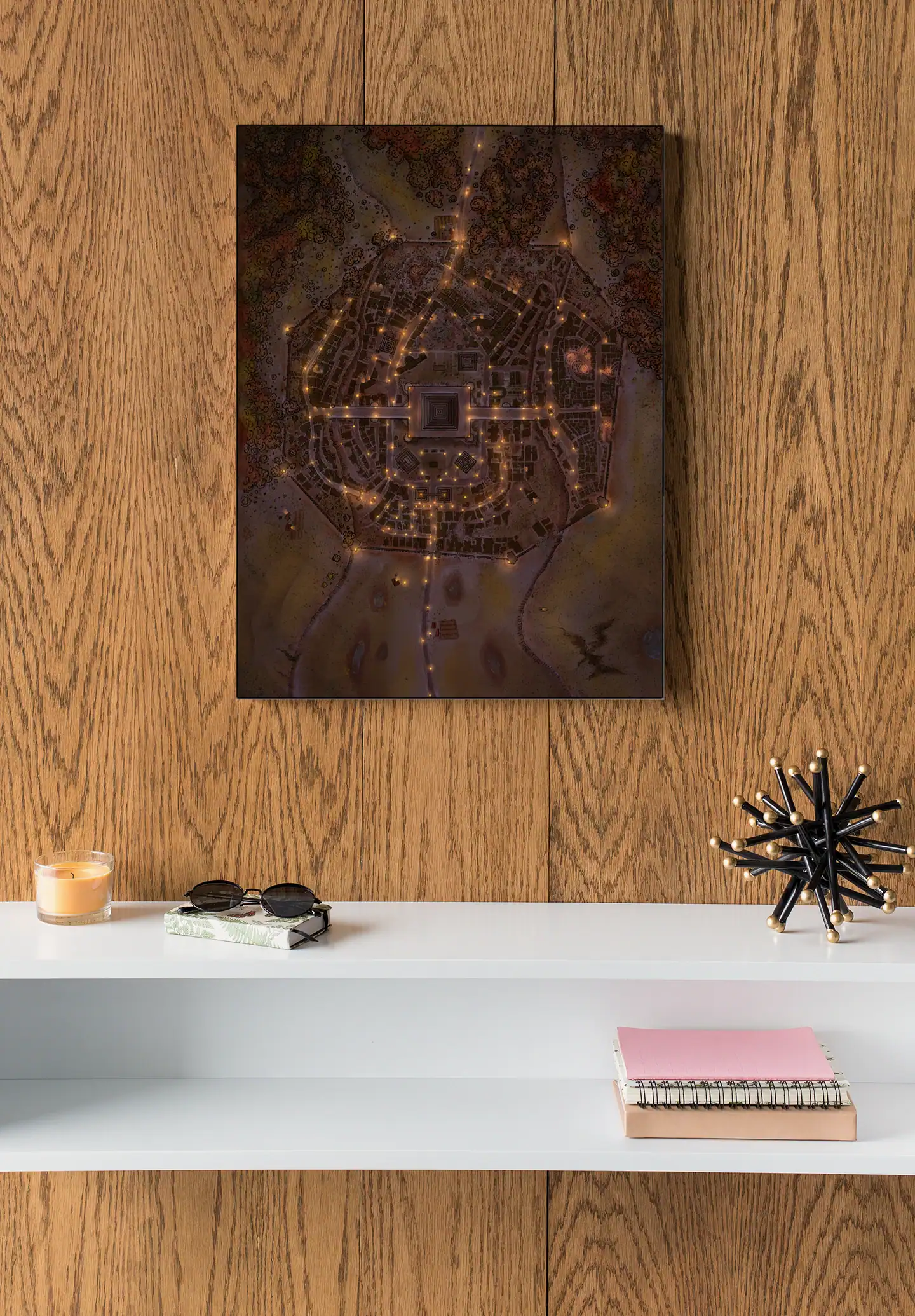 Circular walled city viewed from above with amber street lighting.
