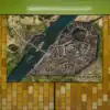 Overhead view of fortified city split by wide river.